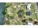 Aerial view of lakefront property, highlighting the spacious lot, mature trees, and serene waterfront at 1042 Golden Bough Rd, Lake Wales, FL 33898