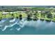 Gorgeous aerial shot of the property with serene lake views, mature trees, and neighborhood at 1042 Golden Bough Rd, Lake Wales, FL 33898