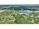 Picturesque aerial view of a sprawling property with a serene lake and verdant land, offering endless possibilities at 1042 Golden Bough Rd, Lake Wales, FL 33898