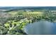 Aerial view of lakefront home near surrounding farmland at 1042 Golden Bough Rd, Lake Wales, FL 33898