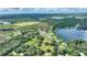 Aerial view of lakefront property with trees and lush greenery at 1042 Golden Bough Rd, Lake Wales, FL 33898