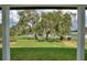 Expansive backyard with mature trees and lake views, creating a serene and picturesque outdoor space at 1042 Golden Bough Rd, Lake Wales, FL 33898