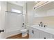 Bathroom featuring a shower-tub, a toilet, and a sink with cabinets at 1042 Golden Bough Rd, Lake Wales, FL 33898