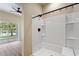 Bathroom with shower and views of the backyard at 1042 Golden Bough Rd, Lake Wales, FL 33898