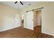 Bedroom with wood floors and sliding barn door to the closet at 1042 Golden Bough Rd, Lake Wales, FL 33898