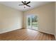 Bedroom with vinyl floors, ceiling fan, and sliding glass doors leading to the backyard at 1042 Golden Bough Rd, Lake Wales, FL 33898