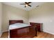 Neutral bedroom featuring a ceiling fan and a dresser for storage at 1042 Golden Bough Rd, Lake Wales, FL 33898