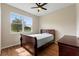 Cozy bedroom featuring a ceiling fan and a large window for natural light at 1042 Golden Bough Rd, Lake Wales, FL 33898