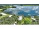 Tranquil lakeside setting showcasing a private boat ramp, dock, and lush green surroundings at 1042 Golden Bough Rd, Lake Wales, FL 33898