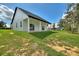 A modern home that features a large yard with a covered back patio that is ideal for relaxing and entertaining at 1042 Golden Bough Rd, Lake Wales, FL 33898