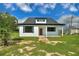 Charming renovated house with a new roof, landscaping, and a classic, inviting facade at 1042 Golden Bough Rd, Lake Wales, FL 33898