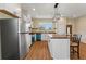 Bright kitchen featuring an island, wood countertops, stainless steel refrigerator, and modern light fixture at 1042 Golden Bough Rd, Lake Wales, FL 33898
