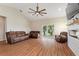 Spacious living room with a fan, a sliding glass door, and comfortable leather seating at 1042 Golden Bough Rd, Lake Wales, FL 33898