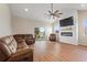 Comfortable living room featuring a fireplace, leather seating, and sliding glass doors to the outside at 1042 Golden Bough Rd, Lake Wales, FL 33898