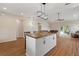 Open-concept kitchen island flowing into the spacious living room with a sliding glass door at 1042 Golden Bough Rd, Lake Wales, FL 33898