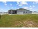 Manicured lawn and white fenced backyard with covered patio providing an outdoor oasis at 1081 Sandpiper Loop, Winter Haven, FL 33881
