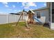 Backyard features a wooden playset, a slide, and well-maintained lawn for Gathering enjoyment at 1081 Sandpiper Loop, Winter Haven, FL 33881