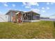 Backyard features a wooden playset, a slide, and well-maintained lawn for Gathering enjoyment at 1081 Sandpiper Loop, Winter Haven, FL 33881