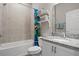 Bright bathroom with shower/tub combination and fun Mario themed shower curtain at 1081 Sandpiper Loop, Winter Haven, FL 33881