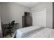 Comfortable bedroom features a large closet, modern dark dresser, and dedicated workspace at 1081 Sandpiper Loop, Winter Haven, FL 33881