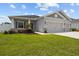 Attractive one-story home featuring gray stucco, a two-car garage, and well-kept front yard at 1081 Sandpiper Loop, Winter Haven, FL 33881