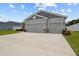 Charming one-story home featuring gray stucco, a two-car garage, and well-kept front yard at 1081 Sandpiper Loop, Winter Haven, FL 33881