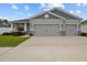 Charming home featuring a two-car garage, stone accents and lush landscaping at 1081 Sandpiper Loop, Winter Haven, FL 33881