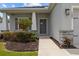 Inviting front entrance with a well-manicured yard and attractive stone pillar accents at 1081 Sandpiper Loop, Winter Haven, FL 33881