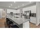 Open kitchen with a large island, seating, stainless steel appliances, and granite countertops at 1081 Sandpiper Loop, Winter Haven, FL 33881