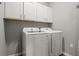 Laundry room featuring a white washer and dryer with white storage cabinets above at 1081 Sandpiper Loop, Winter Haven, FL 33881