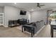 Living room and dining area showcase an open concept with natural light from a sliding door at 1081 Sandpiper Loop, Winter Haven, FL 33881