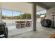 Covered patio includes a large table and chairs, perfect for outdoor entertaining and relaxation at 1081 Sandpiper Loop, Winter Haven, FL 33881
