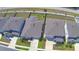 An aerial view highlights a neighborhood with well-maintained homes and green spaces at 1100 Sugarwood St, Davenport, FL 33837