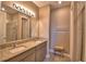 Bathroom featuring double sinks, granite countertops, and a shower at 1100 Sugarwood St, Davenport, FL 33837