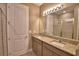 Bright bathroom with double sinks, shower, and warm neutral colors at 1100 Sugarwood St, Davenport, FL 33837