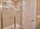 Bathroom showcasing a glass-enclosed shower with tiled walls and floors at 1100 Sugarwood St, Davenport, FL 33837