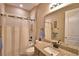 Neat bathroom with granite countertop, bath tub and shower, plus complete fixtures at 1100 Sugarwood St, Davenport, FL 33837