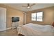 A comfortable bedroom with a ceiling fan, natural light, and a TV for relaxing at 1100 Sugarwood St, Davenport, FL 33837