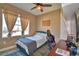 Cozy bedroom with natural light, ceiling fan, and modern design at 1100 Sugarwood St, Davenport, FL 33837