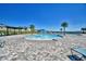 Beautiful community pool area with zero entry splash pad and lounge chairs at 1100 Sugarwood St, Davenport, FL 33837