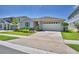 Charming single-story home with manicured lawn and a two-car garage at 1100 Sugarwood St, Davenport, FL 33837