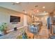 Open living space with kitchen, island seating, and view of comfortable living room at 1100 Sugarwood St, Davenport, FL 33837