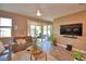 Inviting living room featuring tile floors, comfortable seating, and access to screened patio at 1100 Sugarwood St, Davenport, FL 33837