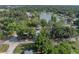 Aerial view of the property with a lake nearby, surrounded by mature trees and serene surroundings at 1140 W Seminole Trl, Bartow, FL 33830
