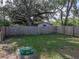 The full fenced backyard has mature trees for shade and a retro septic tank cover at 1140 W Seminole Trl, Bartow, FL 33830