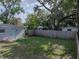 The backyard features a full fence, mature trees and a detached garage at 1140 W Seminole Trl, Bartow, FL 33830