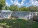 A spacious backyard reveals a detached garage and mature trees for shade at 1140 W Seminole Trl, Bartow, FL 33830