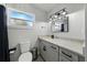 Bathroom featuring gray vanity, updated sink fixtures, and modern commode at 1140 W Seminole Trl, Bartow, FL 33830