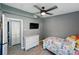 Bedroom with ceiling fan and light and a television mounted on the wall at 1140 W Seminole Trl, Bartow, FL 33830