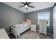 Cozy bedroom featuring a ceiling fan, a window, tile floors, and dresser at 1140 W Seminole Trl, Bartow, FL 33830